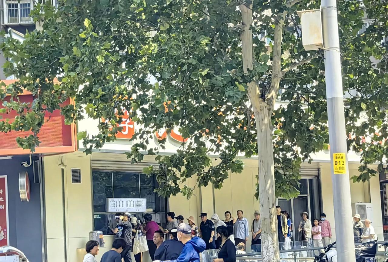济南窑头路，某包子店门口依然是排着长队，这么热的天三十七八度的高温，这得有多么好