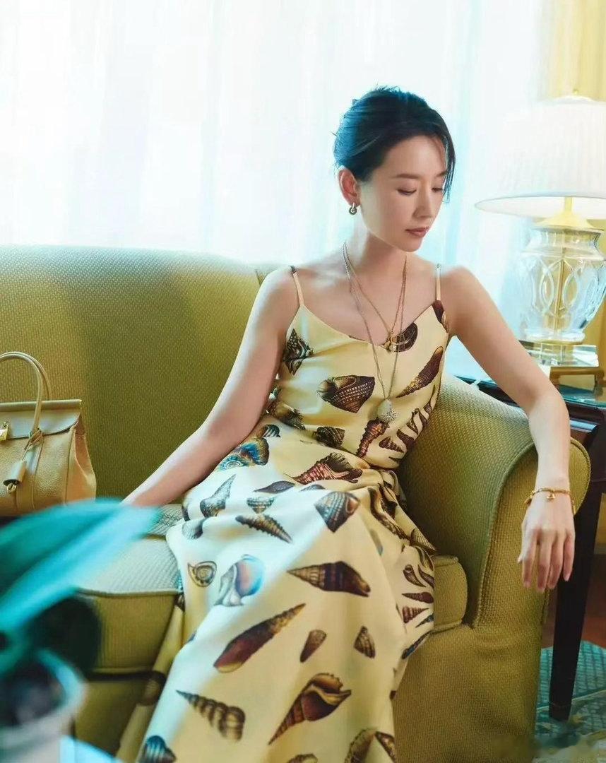董洁气质清雅出众，身着暖黄色印花长裙，温婉端庄的氛围感扑面而来