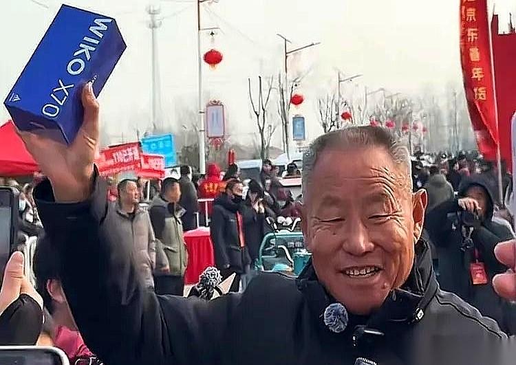 刘强东回村发年货，里三层外三层围满了人，他从一堆礼品里，单独拎出来一个手机盒，递