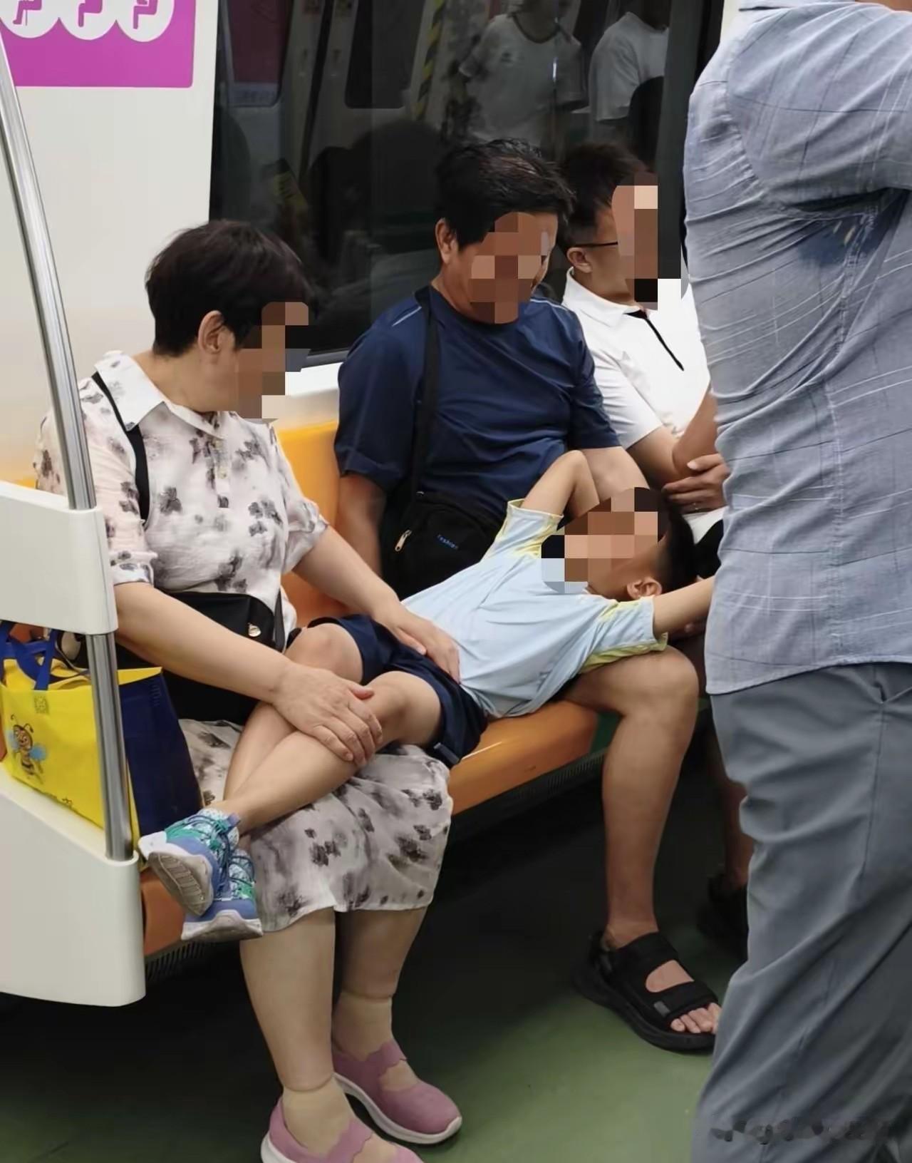 西安地铁上的一幕，两个老人坐在座位上，孙子仰面躺在两老的腿上睡着了，网友为