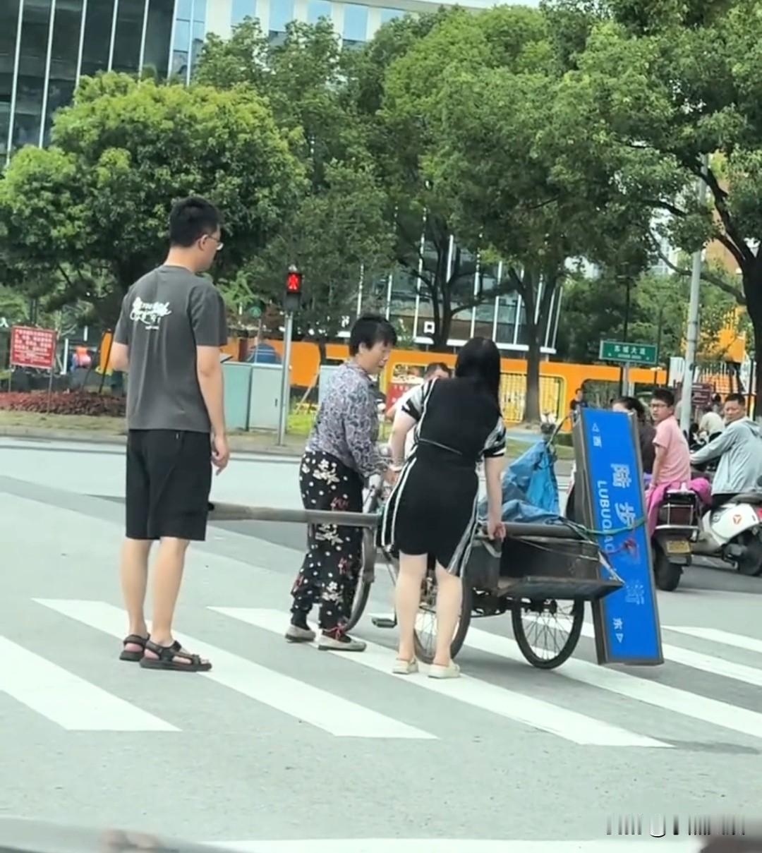 简直无语。路人劝阻告诉她这是路牌你不能带走，老人说我相中了。一老人骑着三轮