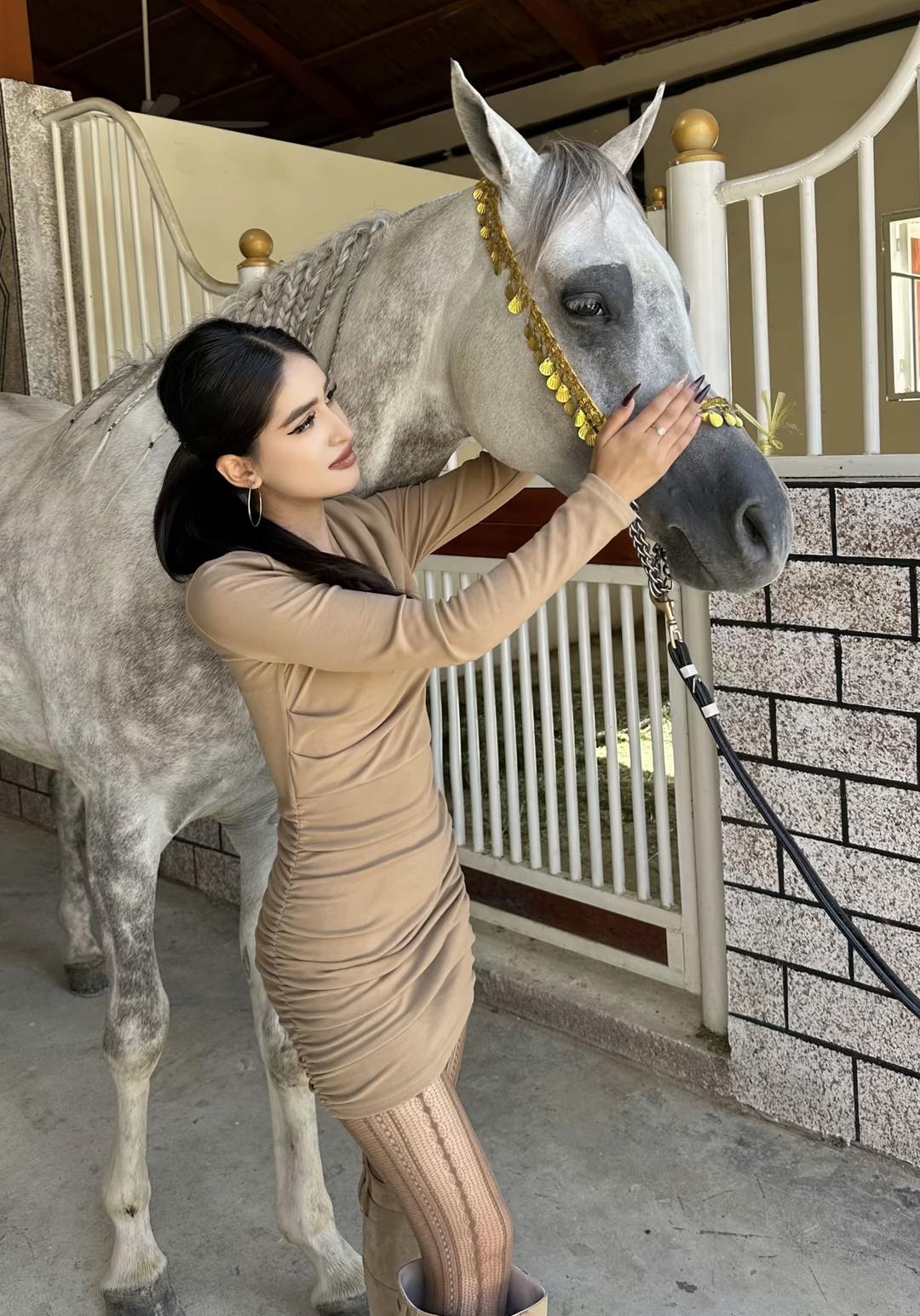 美人抚马，情意绵绵。