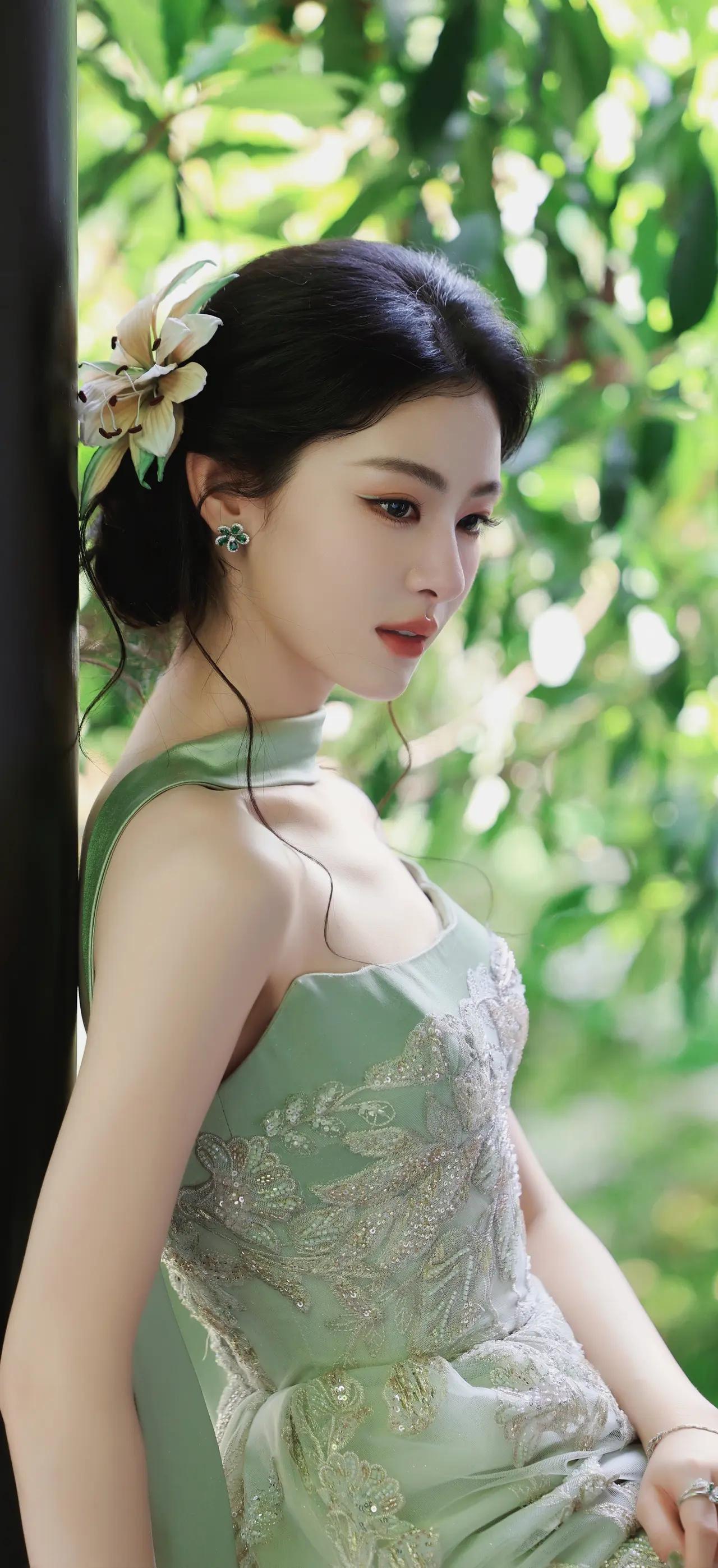 美女壁纸～绿意漫过窗棂，浅绿礼服缀着细碎星光，鬓边百合轻颤，将春日的温柔与江南的