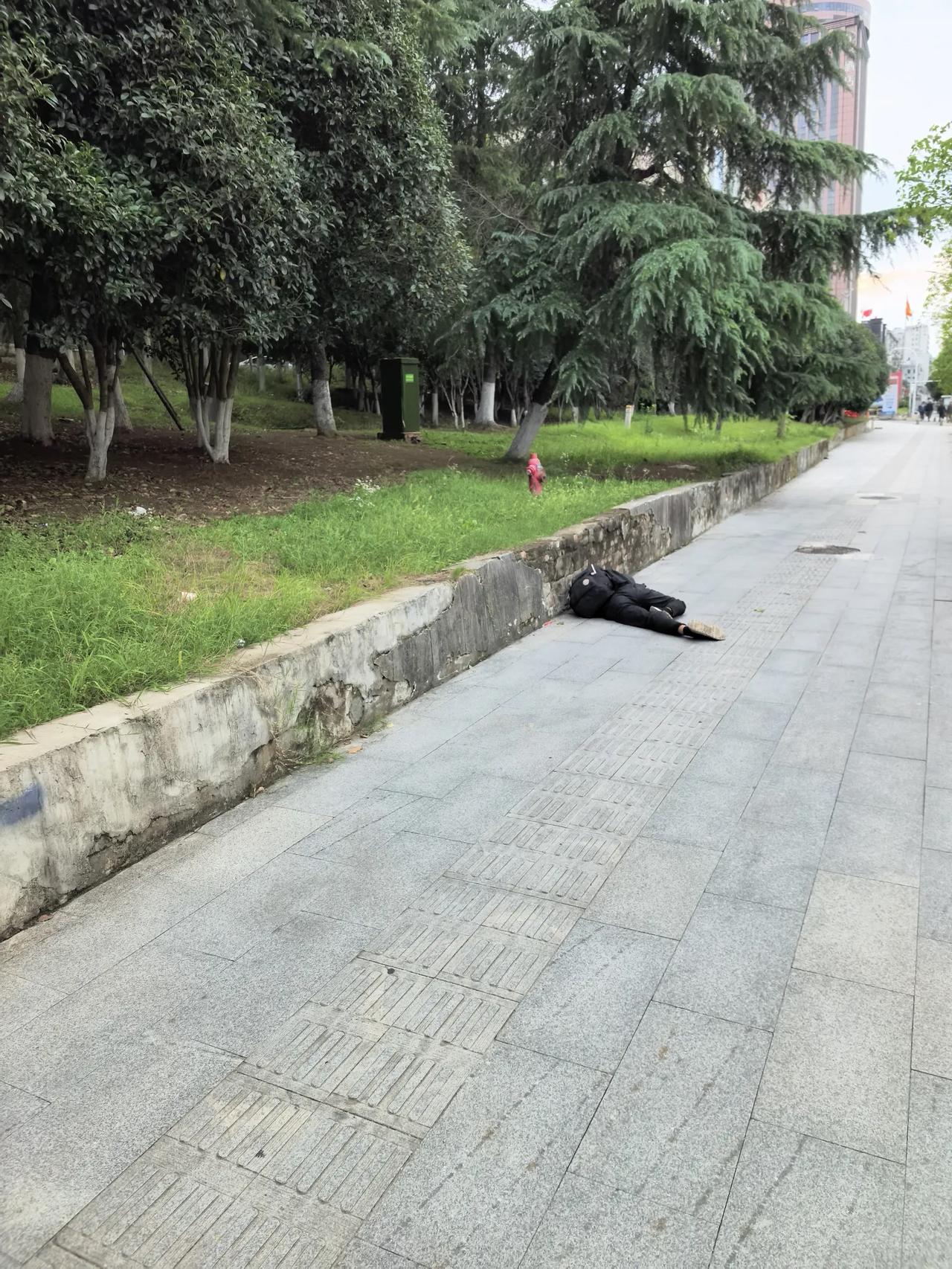 走在街道上，突然看到路边躺着一个男人，像是中年人，背着一个包，腿在颤抖。我的第一