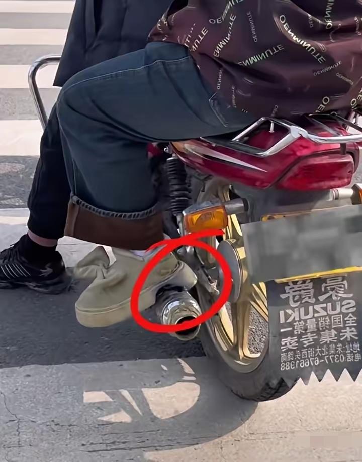 一搭摩托车的女人，她的厚底鞋搭在摩托车冒烟管上。厚底鞋被烫了一个大坑，等她下车后