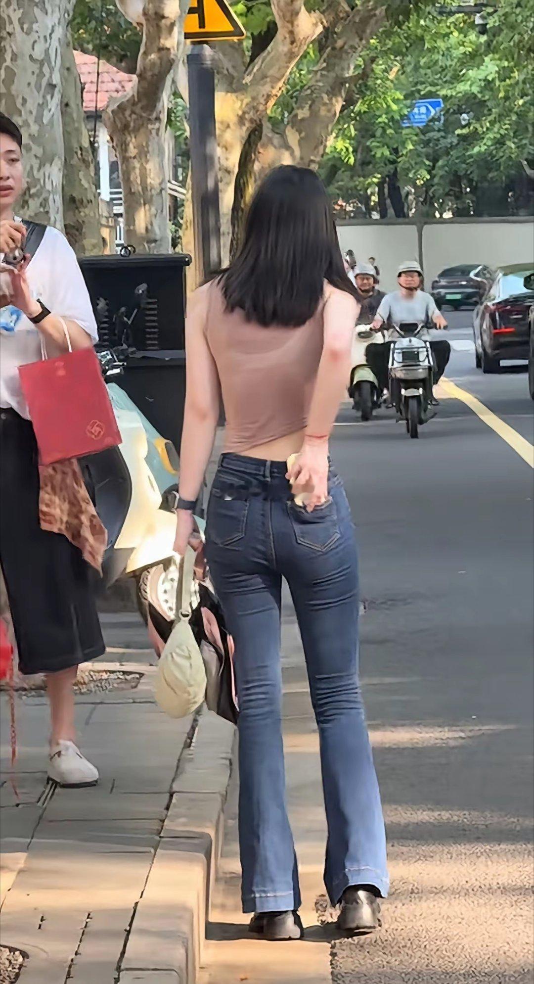 这个男人一定很喜欢他女朋友，在大街上给他女朋友拍好看的照片！
