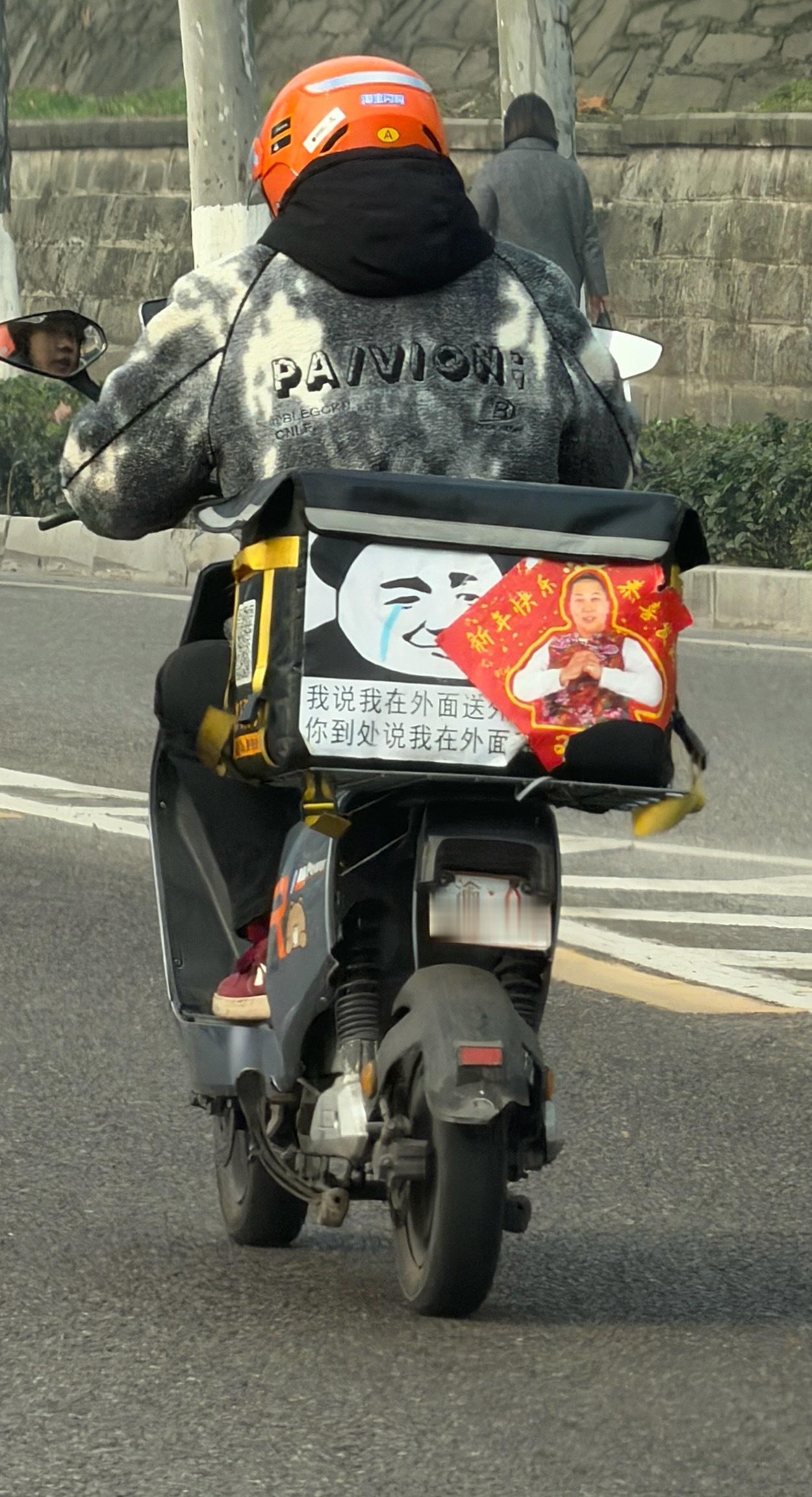 偶遇一个有意思的外卖小哥、在机车后面贴的标语：“我说我在外面送外卖、你到处说我