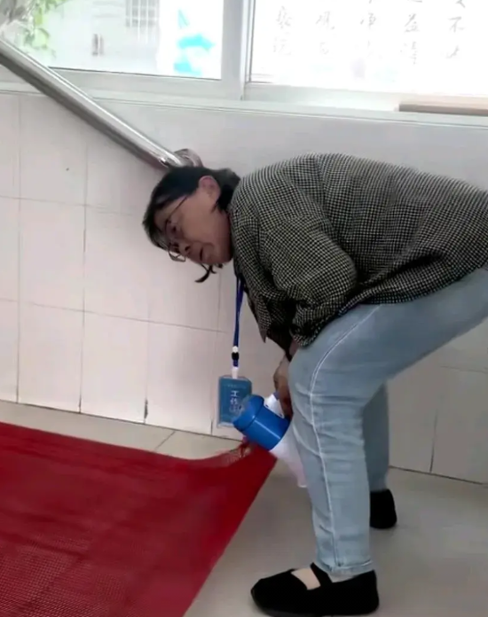 张桂梅校长整理学校食堂门口的地垫视频下面，有国外网友问：“中国人，读书尽头是为了