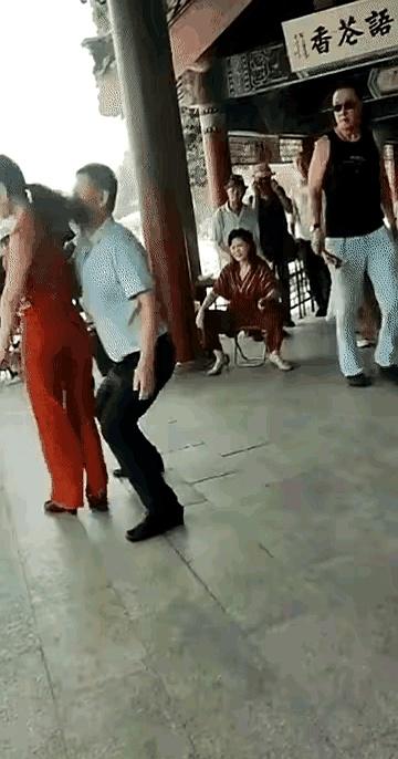 白衣大叔和红衣美女还在场子里跳得起劲，上一刻脚步还踩着音乐，下一秒人就直挺挺往地