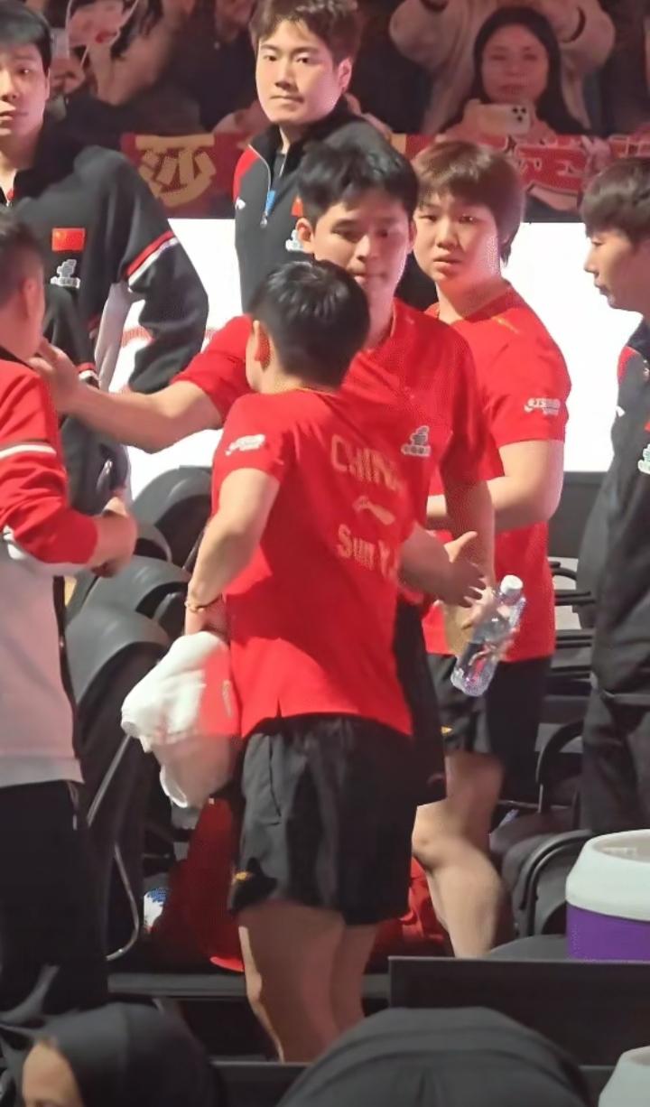 孙颖莎正和马导在那儿商量事儿呢，旁边的小石头在干啥？眼睛一直紧紧盯着孙颖莎，都不