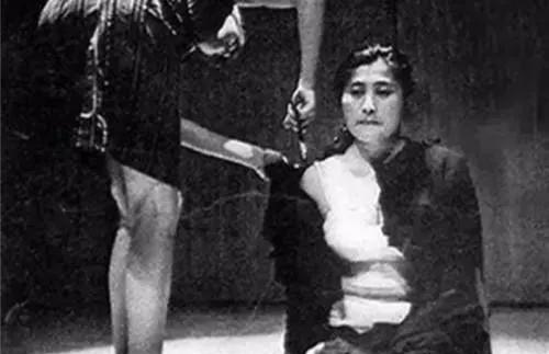 1964年日本，一位看起来貌美优雅的女士跪坐在地上，对着面前百十人说道：“来吧，