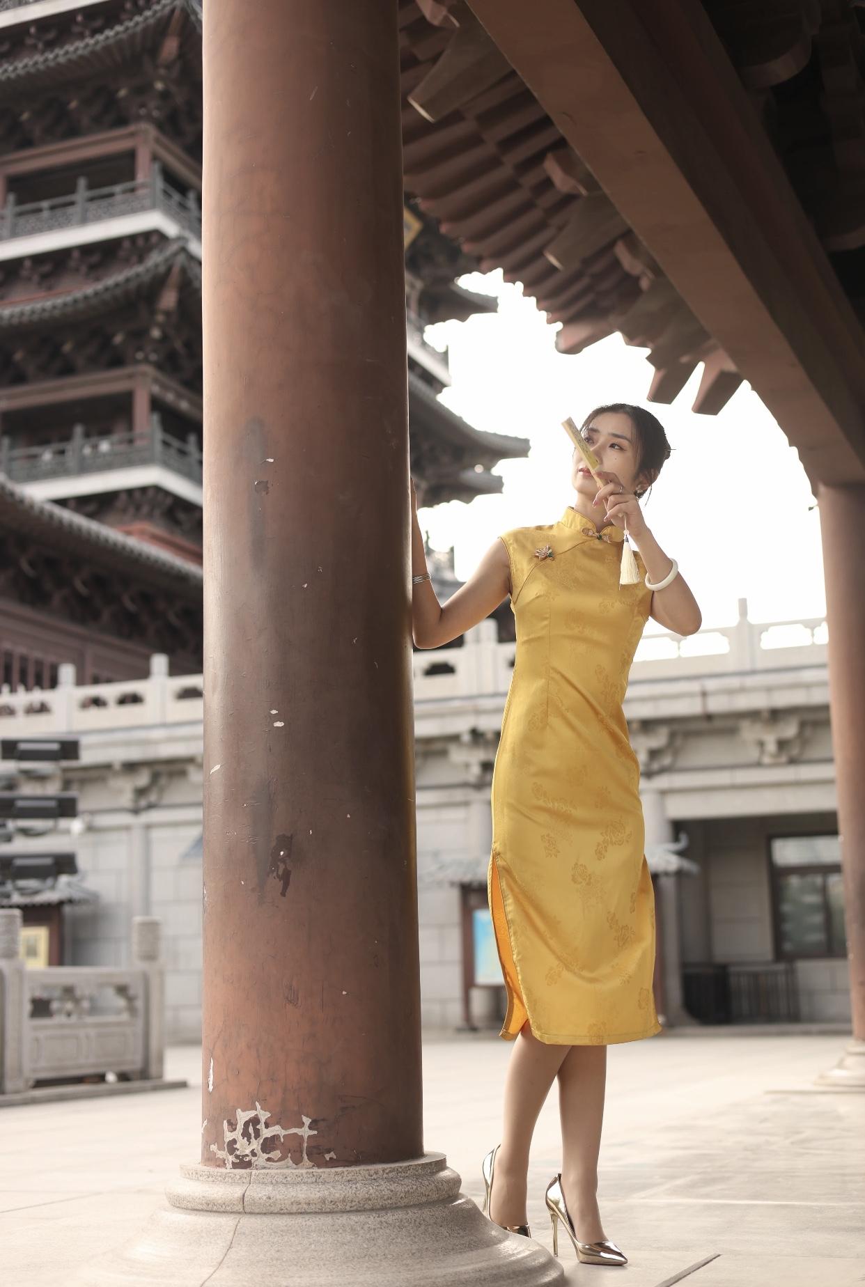 女人如何穿出含蓄的性感?古风古韵，黄衣美人倚古塔，手持团扇，韵味十足。