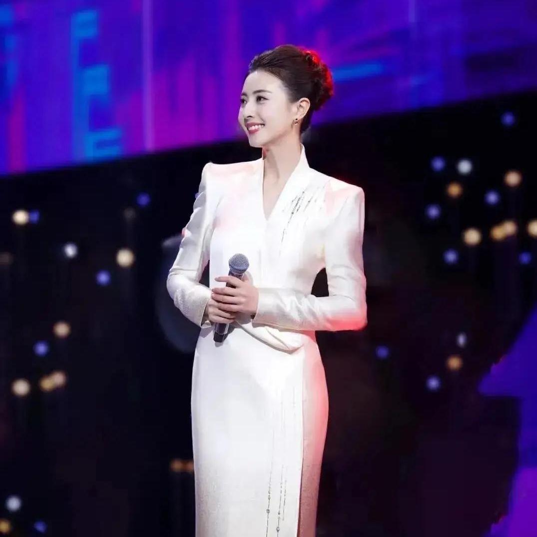 她往台上一站，整个人都亮闪闪的。皮肤白得透亮，长得清爽又大气，那种知性优雅的劲儿
