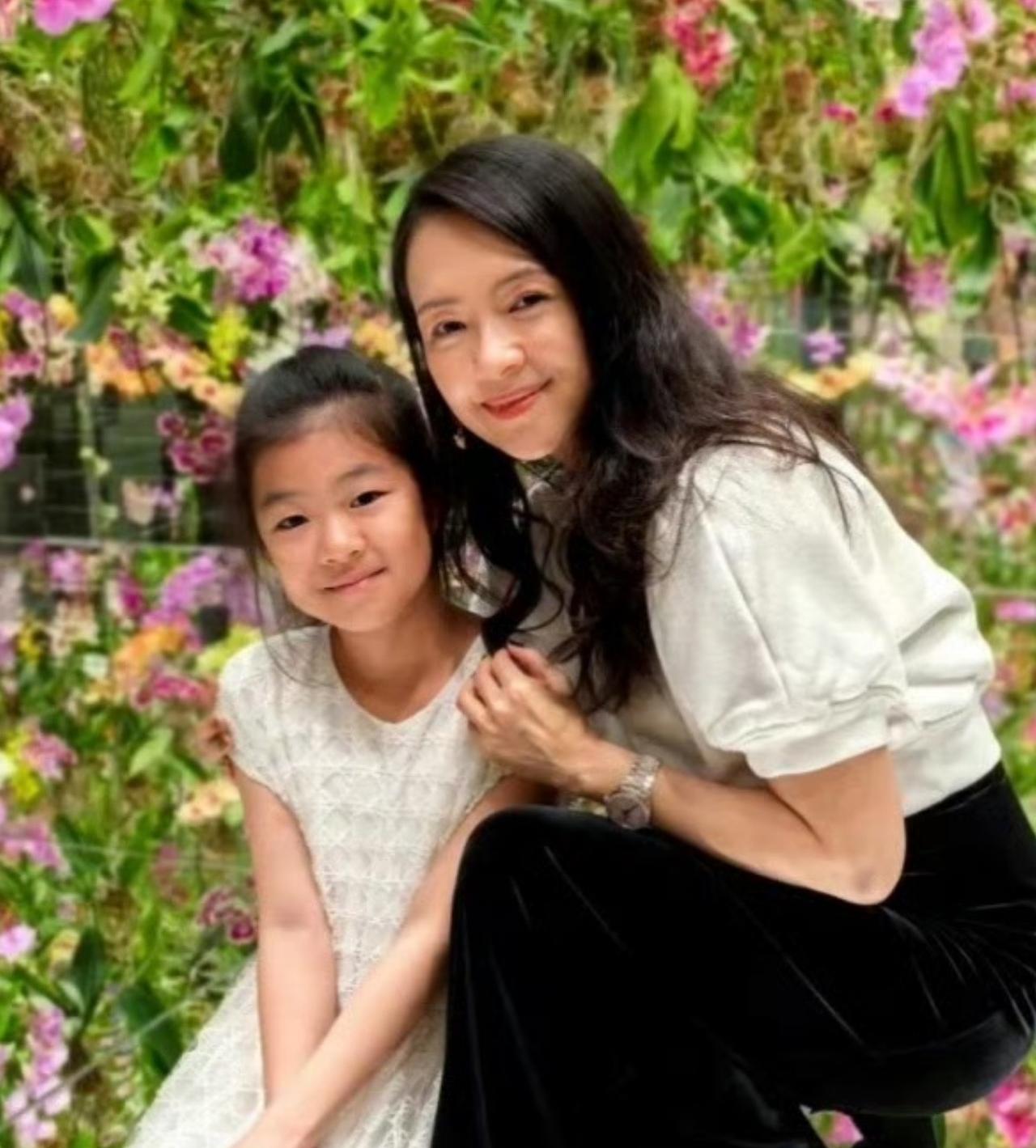 章子怡和10岁的女儿醒醒，依偎在花丛中，留下这温馨的一幕。醒醒从小就被吐槽，颜值