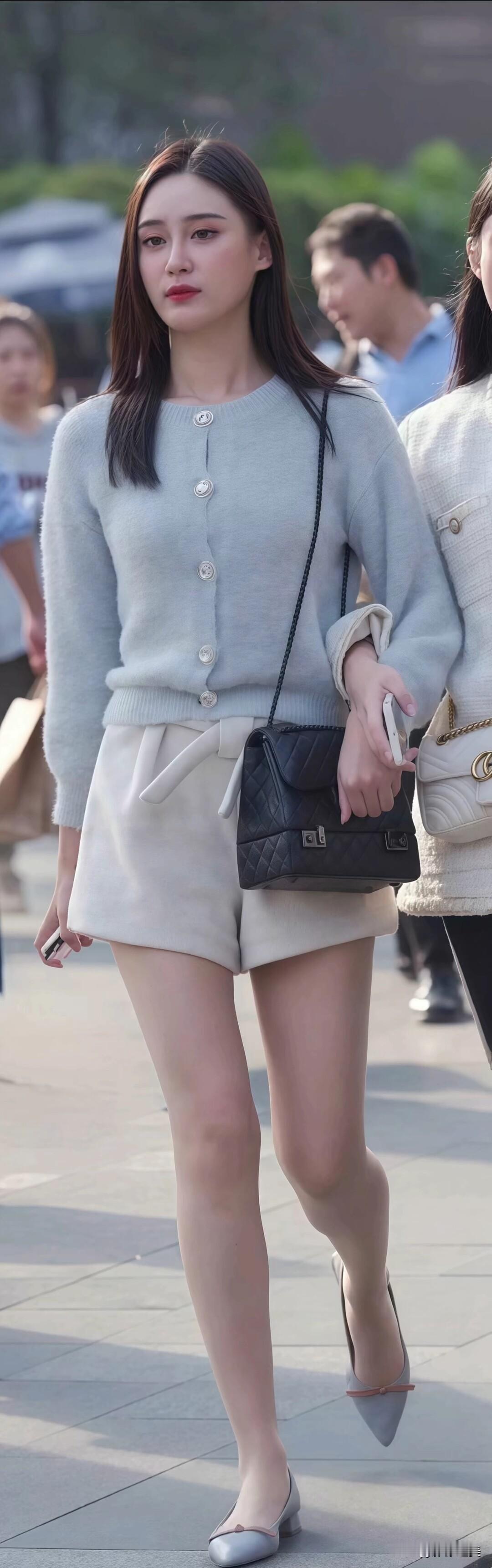 浅灰色针织开衫配米白短裤，温柔又显气质，再搭个精致小挎包，是适合踏青逛街的穿搭。