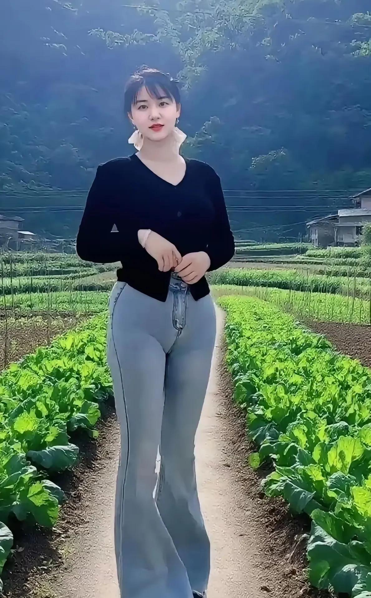 《乡间丽影》翠野田畴小径通，佳人立处韵如风。黑衣素裤添清逸，笑对青山意自融。