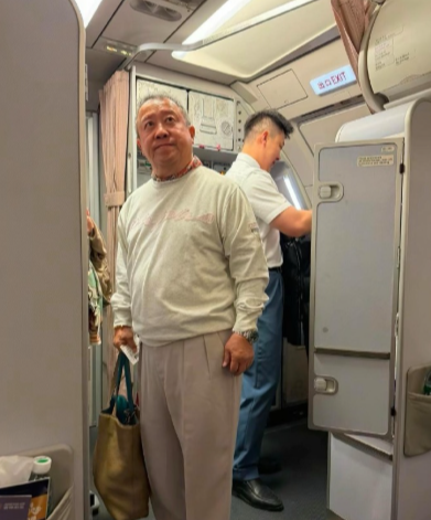73岁曾志伟在深圳坐飞机被偶遇，他坐头等舱，头发花白了，身材臃肿，站立时佝偻着腰