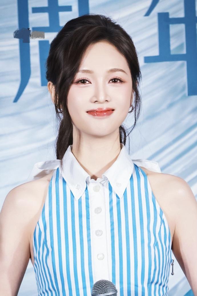 今天吴宣仪在出席活动的时候穿了一件蓝色的条纹裙，看起来像个靓丽的美少女。吴宣