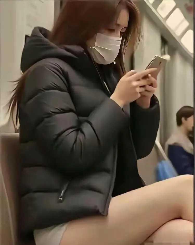 上班穿羽绒服配短裤，冷了还是美了，她图个啥一大早地铁里冷得很，看到个
