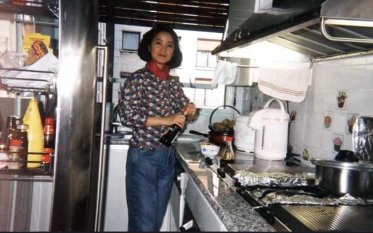 1991年，38岁的邓丽君在法国家的厨房里下厨，这摆设和布局和国内厨房没什么两样