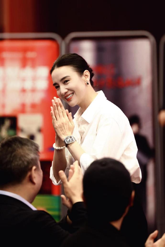 她上身穿白色衬衣，下身搭配黑色裤子，展现出了完美的身材比例，真的是太美了。宋