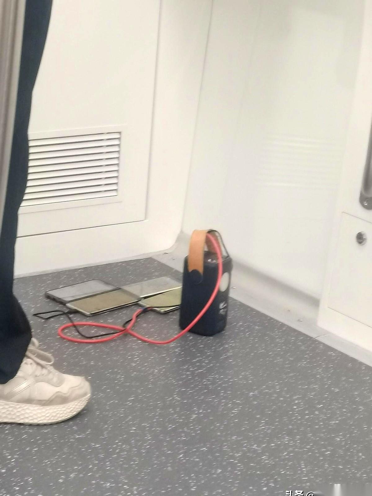 地铁门一开，上来个男的，一屁股坐下，就从包里往外掏东西。一部，两部，三部……当