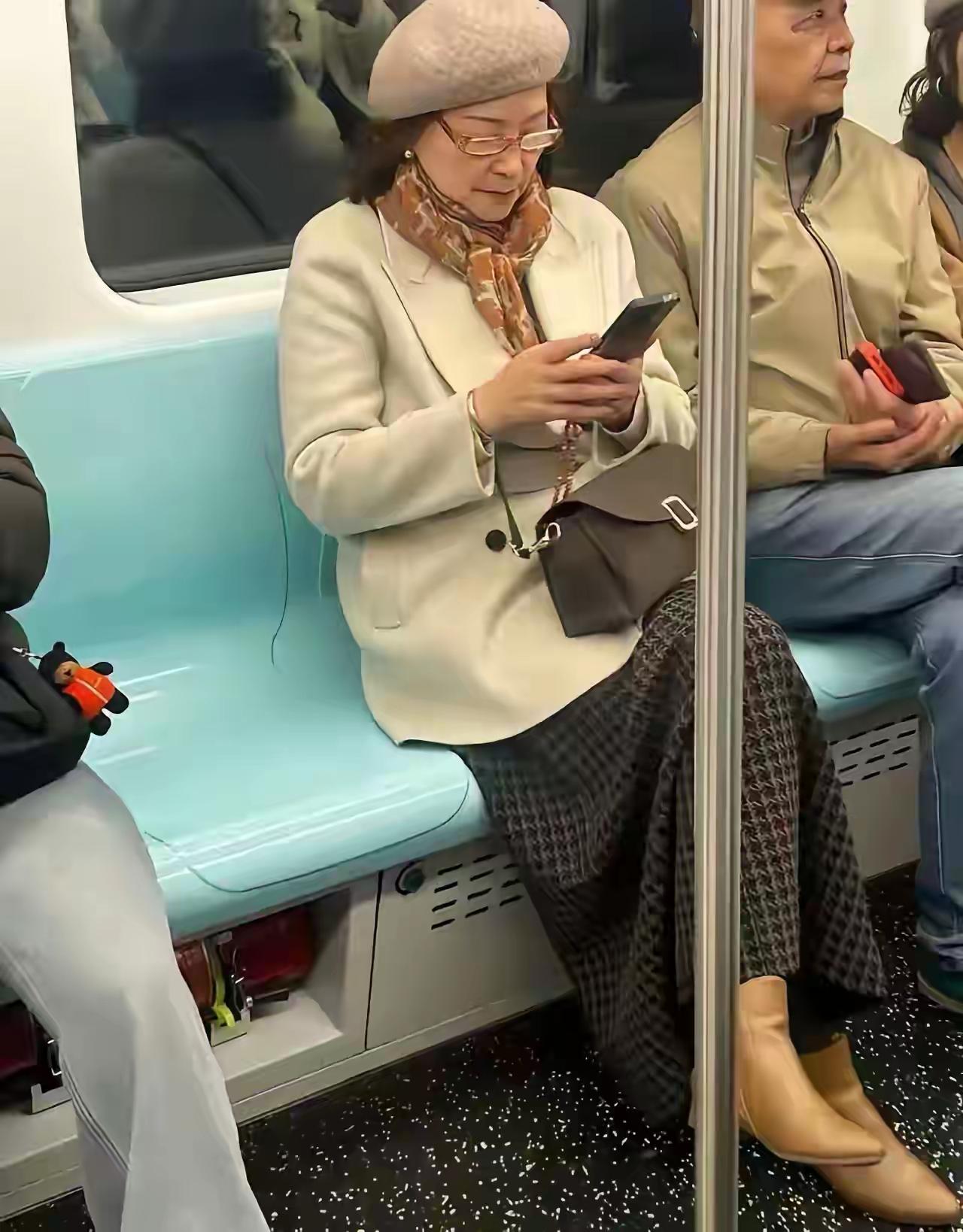 哇！这位老人真有气质，身着一袭米色双羊绒大衣，搭配花格子裙，头上的贝雷帽更衬出其