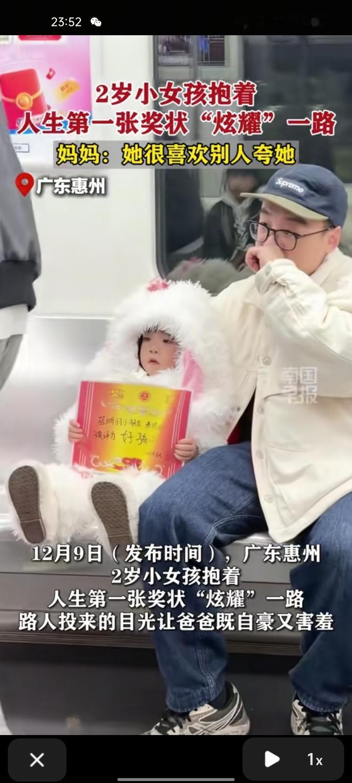 12月9日，广东惠州。两岁小女孩抱着人生第一张奖状“炫耀”一路，路人投来目光让爸