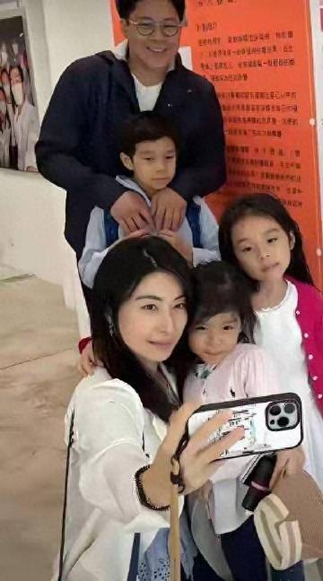 碰到霍启刚一家五口逛街，郭晶晶牵着小女儿，大女儿边走边看书