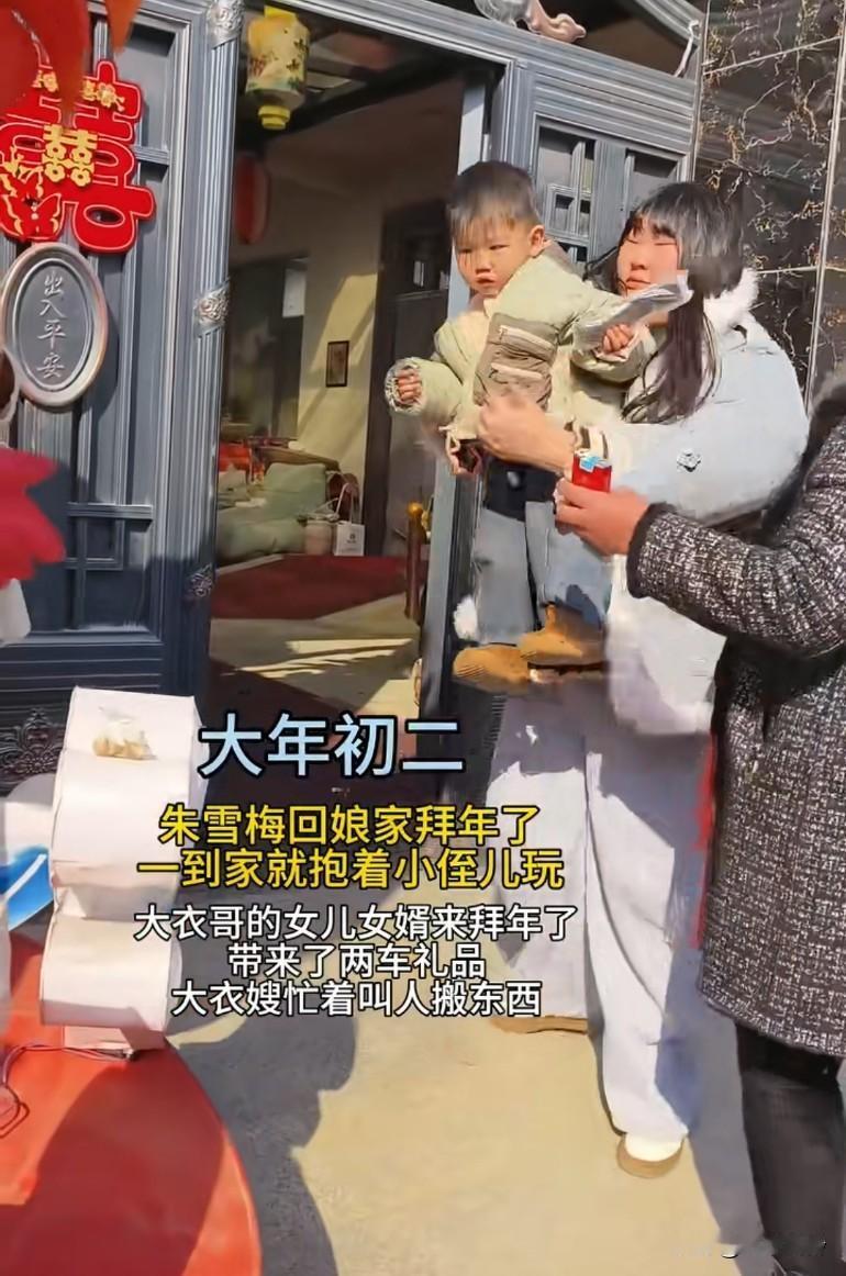 大年初二朱雪梅回娘家拜年了，一到家就抱着小侄儿玩，带来了两车礼品，大衣嫂忙着叫人