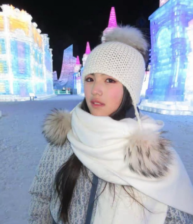 这才是王诗龄该有的样子，在哈尔滨冰雪大世界游玩，穿浅蓝色波点羽绒服，头戴白色帽子
