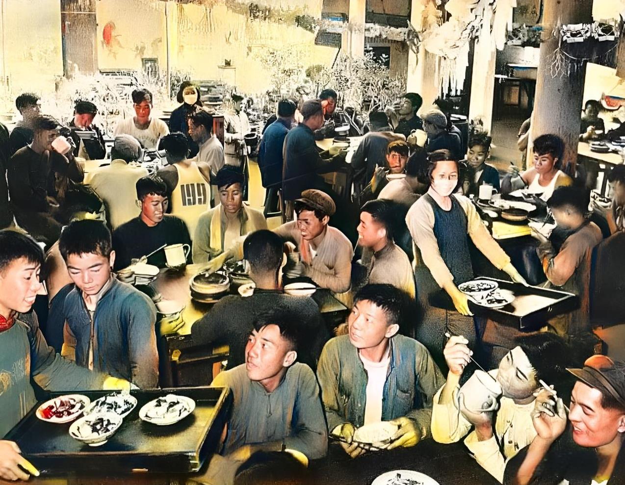 1958年，人民公社的大食堂里热闹非凡。每一张饭桌旁都坐满了社员。每一名社员的脸