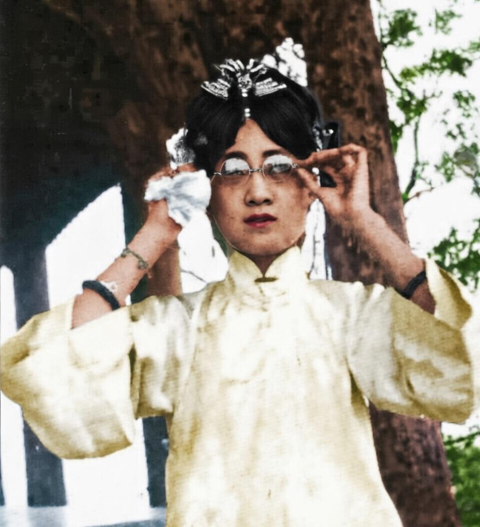 这张照片的是末代皇帝溥仪的皇后郭布罗·婉容，她身着素净的白色立领便装，头戴精致的