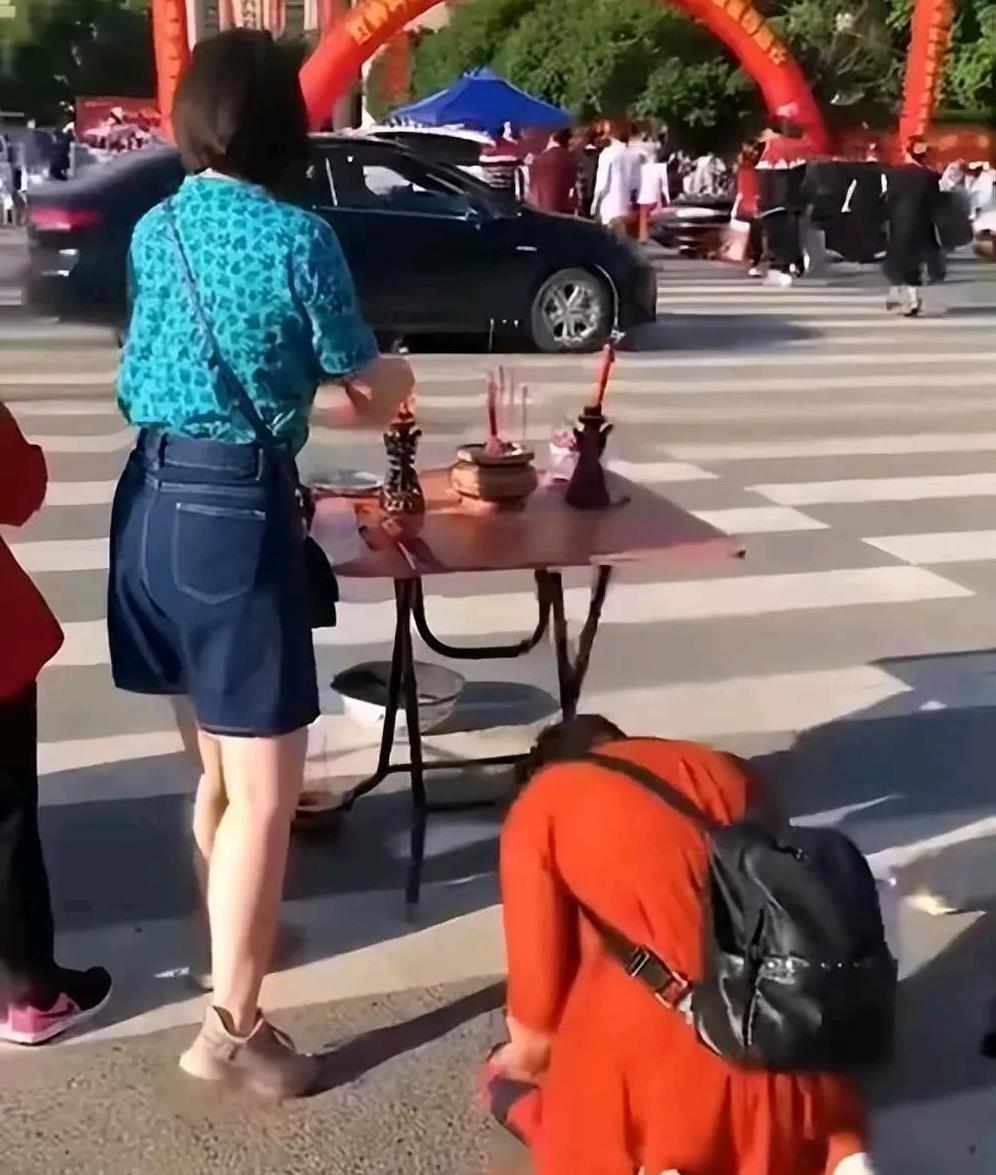 高考陪考中的荒诞景观：家长将焦虑转化为迷信表演，将教育期盼异化为滑稽仪式，最终使