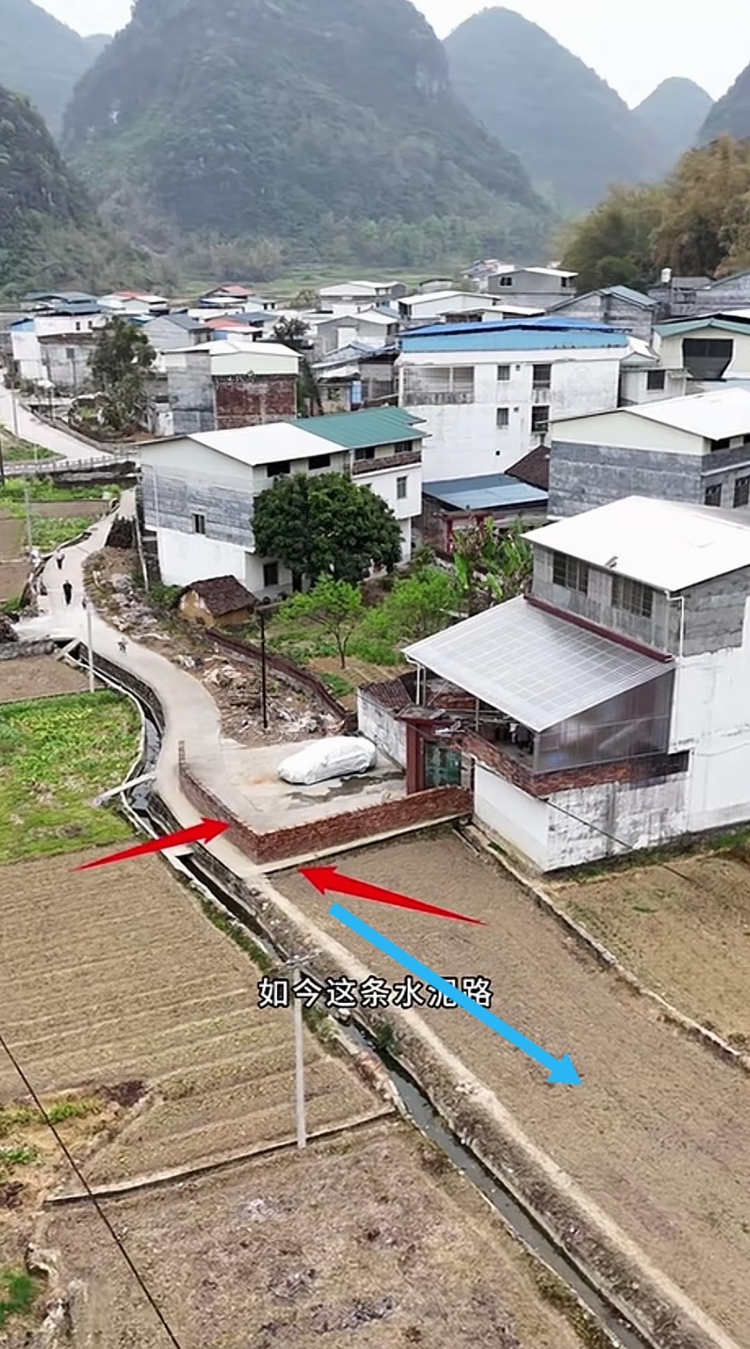 只因一户人家的固执，在自家屋前的路中央砌起一堵围墙，让原本连贯直通的水泥路变成了