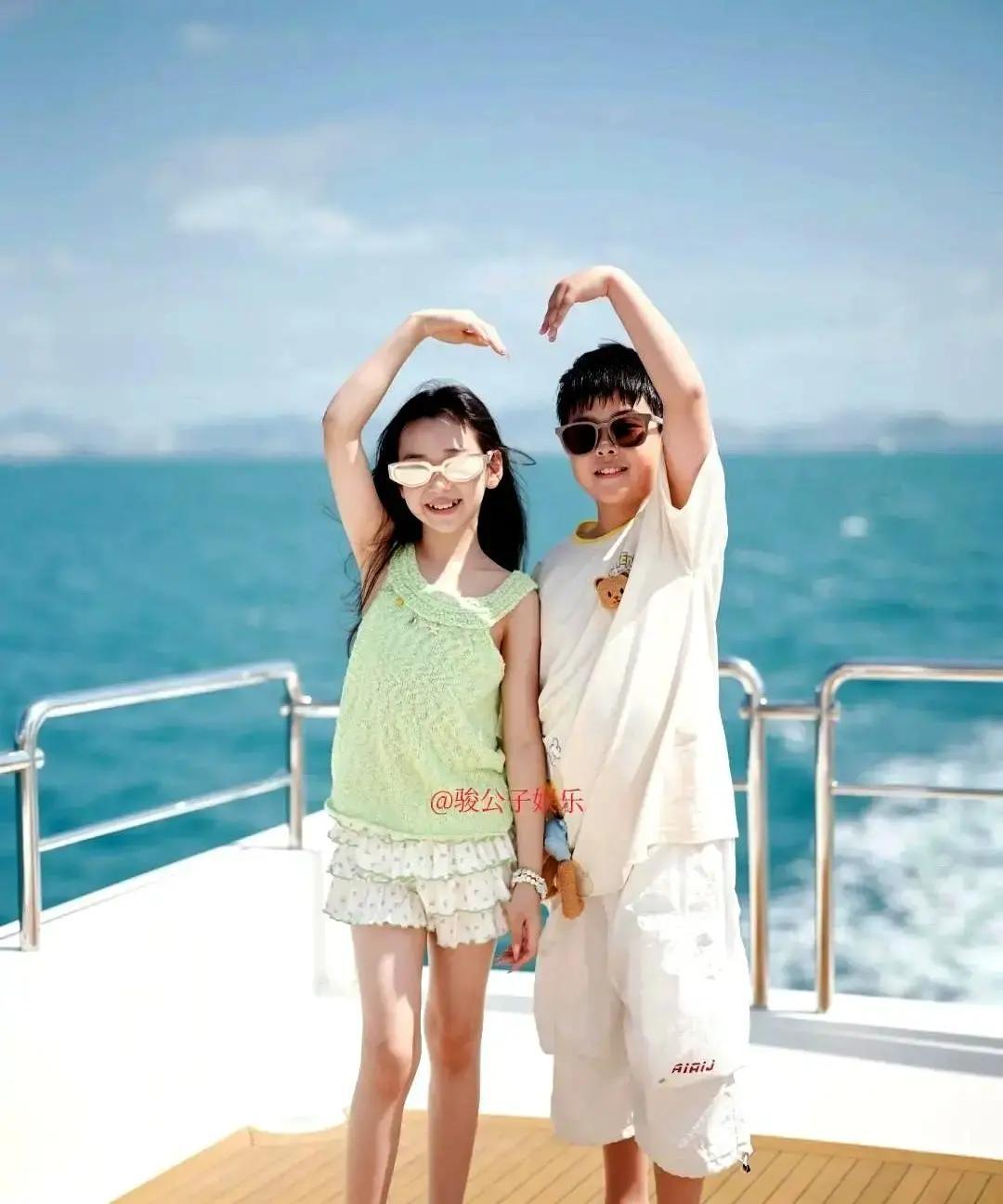 佟丽娅和董璇带着俩娃在三亚被网友偶遇。照片里四个人在泳池边玩水，小酒窝和朵朵