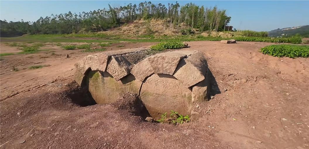 前阵子我去重庆玩，看见水库干得厉害，边上趴着两个石头棺材。其中一块刻着清朝道光年