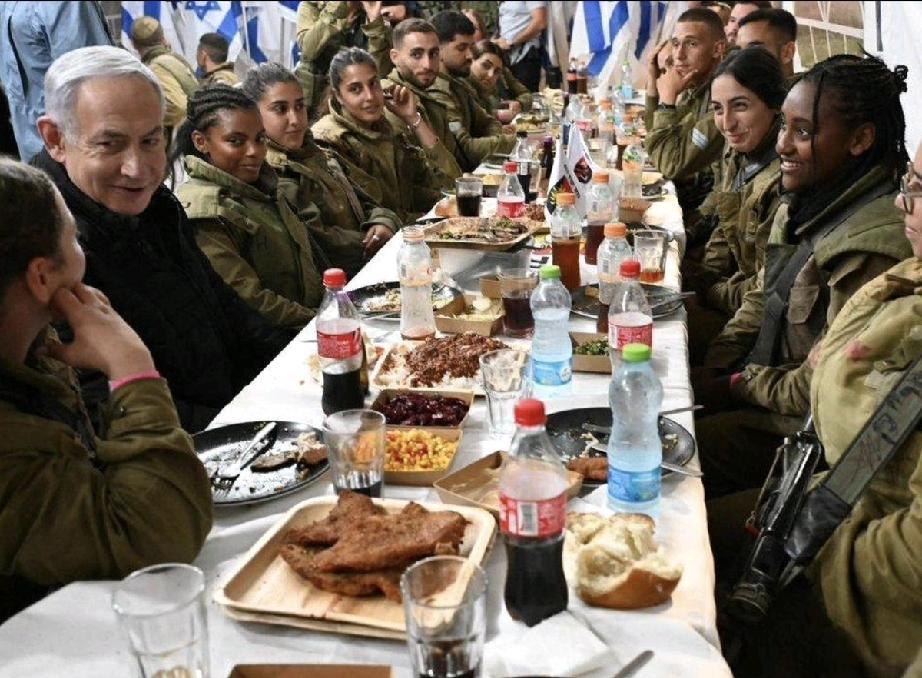 内塔尼亚胡笑的很温暖，他和士兵们在聚餐；和路人聊天的内塔尼亚胡，状态很放松。