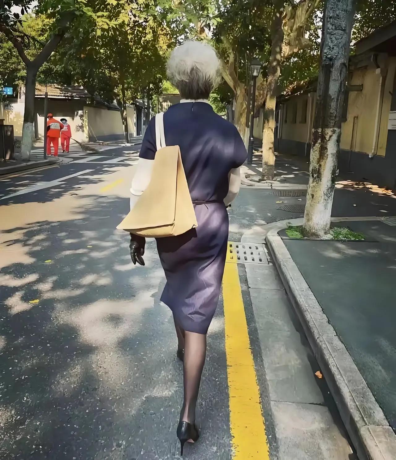 谁说人老了就不能时髦打扮了？看看这位大妈，这身姿，这身段，这打扮这步伐，跟明星没