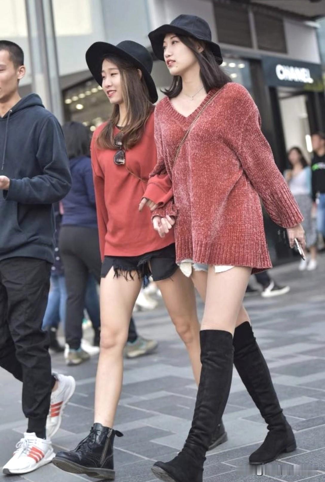 闺蜜手牵手逛街，时尚穿搭显个性