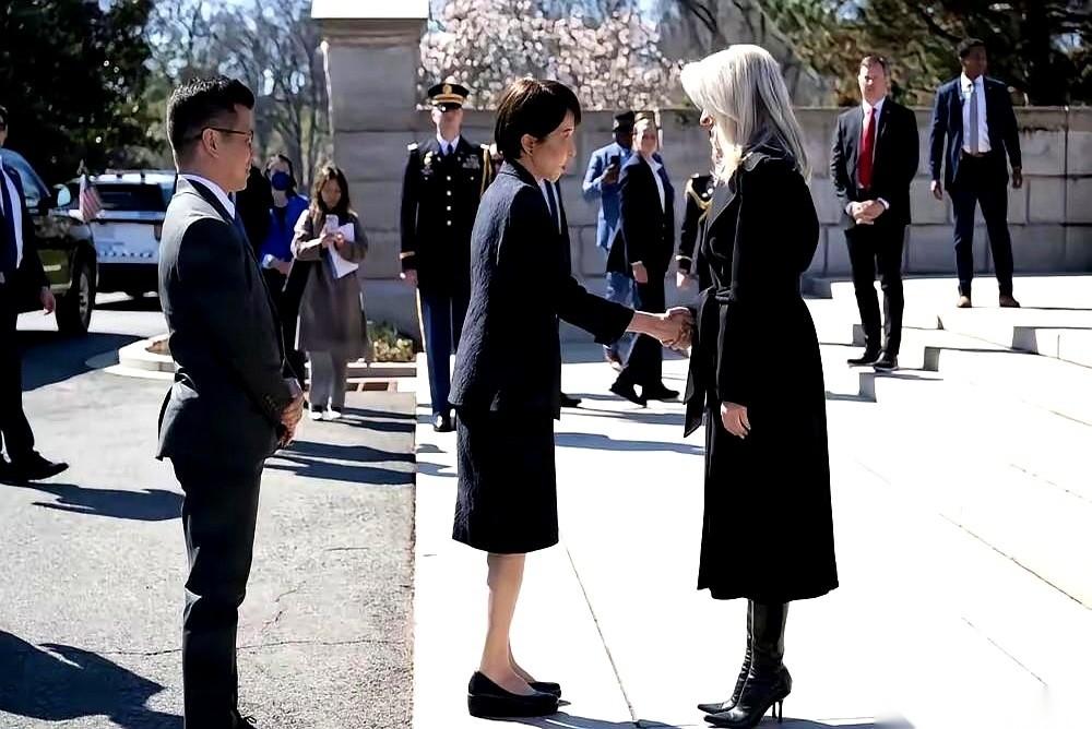 高市早苗那双鞋，比她的鞠躬更诚实。旁边美国女官员穿的是尖头细高跟，每一步都像踩