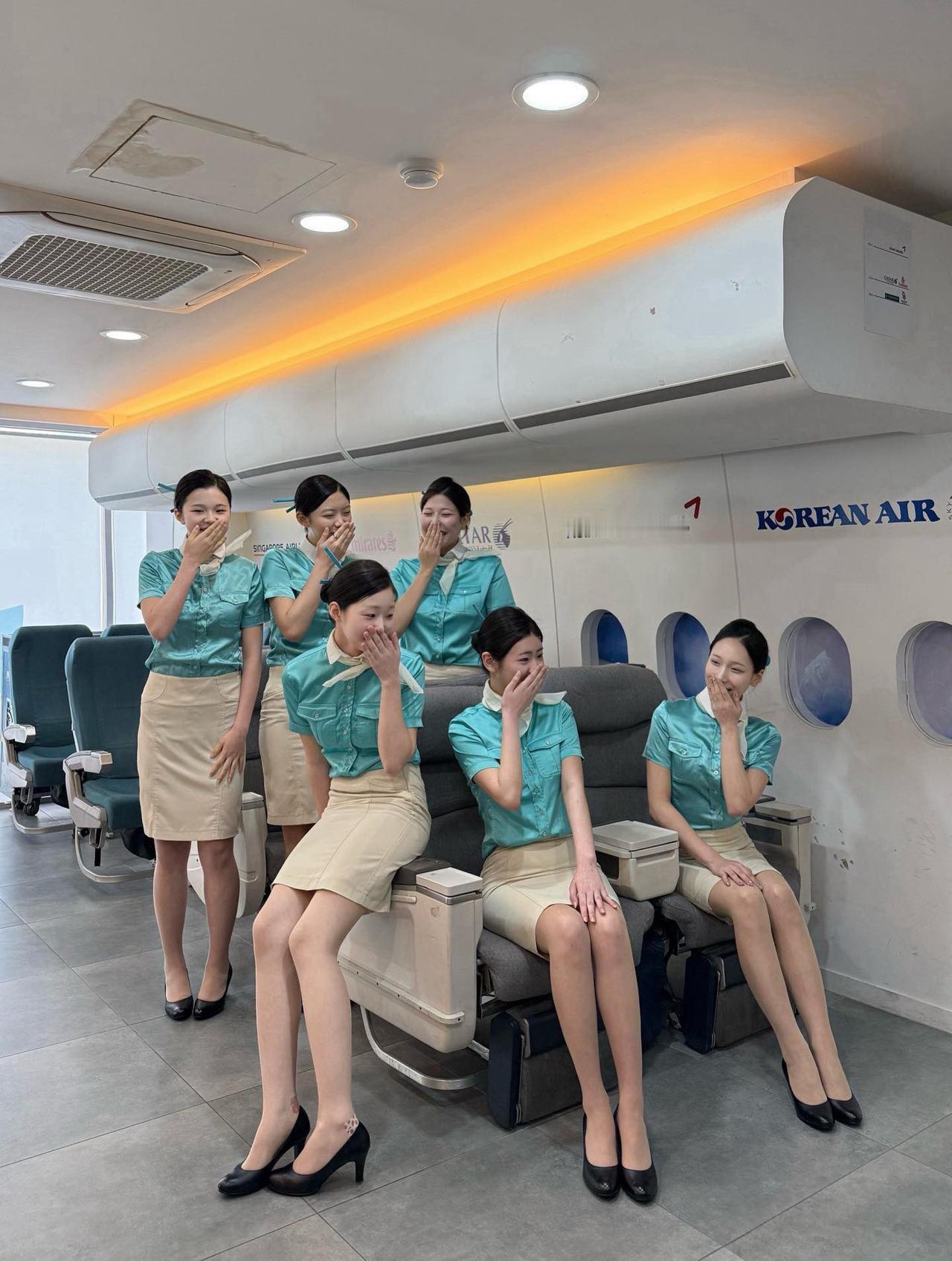 在柔和的LED灯光下，青绿制服映衬的商务舱座椅宛如精致的咖啡桌，窗外绵延的云朵与