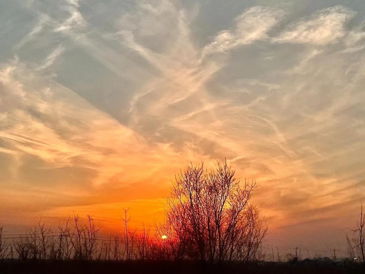 日落时分，天际绽放出绝美画卷。夕阳如火球般缓缓下沉，将天空染成橙红、粉紫，层次分