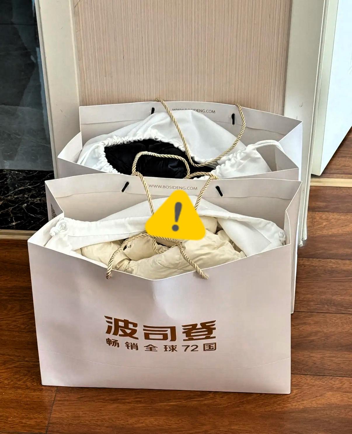 杭州一女子在商场波司登给老公孩子各挑一件羽绒服，结账4898，可店员笑眯眯递来一