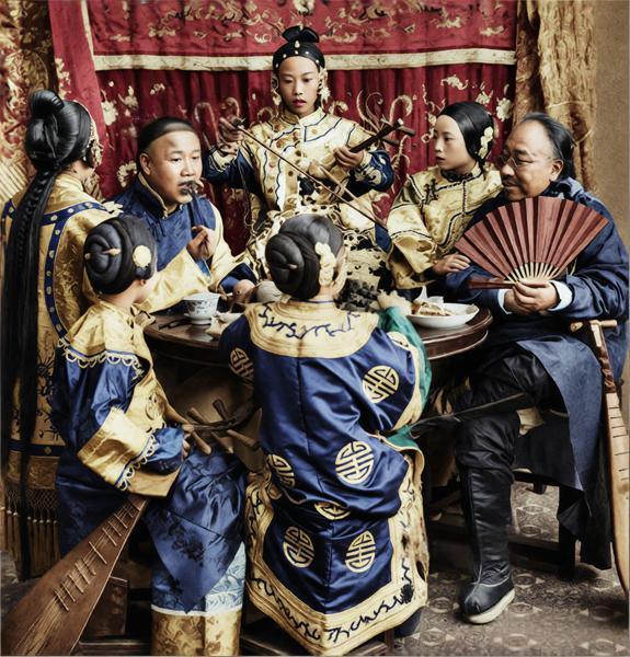 这张照片还原了1901年左右清末富裕商人的私宴娱乐场景，是当时城市上层社会生活风