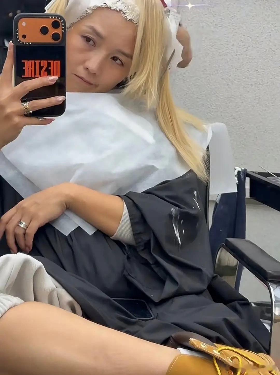 何洁去理发店漂头发，年前再染一次浅色，她翘着二郎腿坐在椅子上有点拽拽的，生完三个