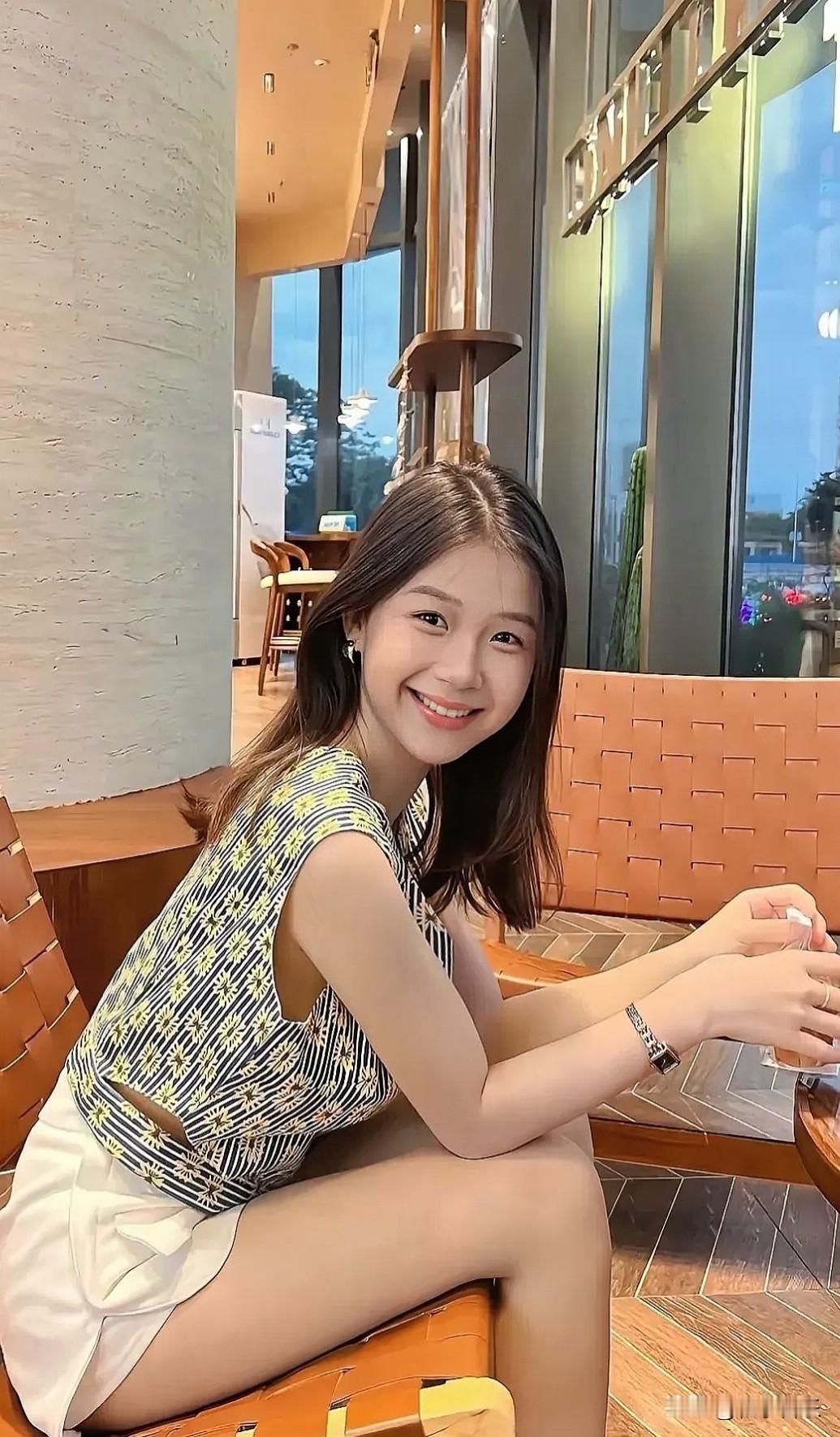 小姐姐穿着清爽无袖上衣和白色短裤，在咖啡馆里微笑自拍，轻爽松弛感爆棚！晒图笔记大