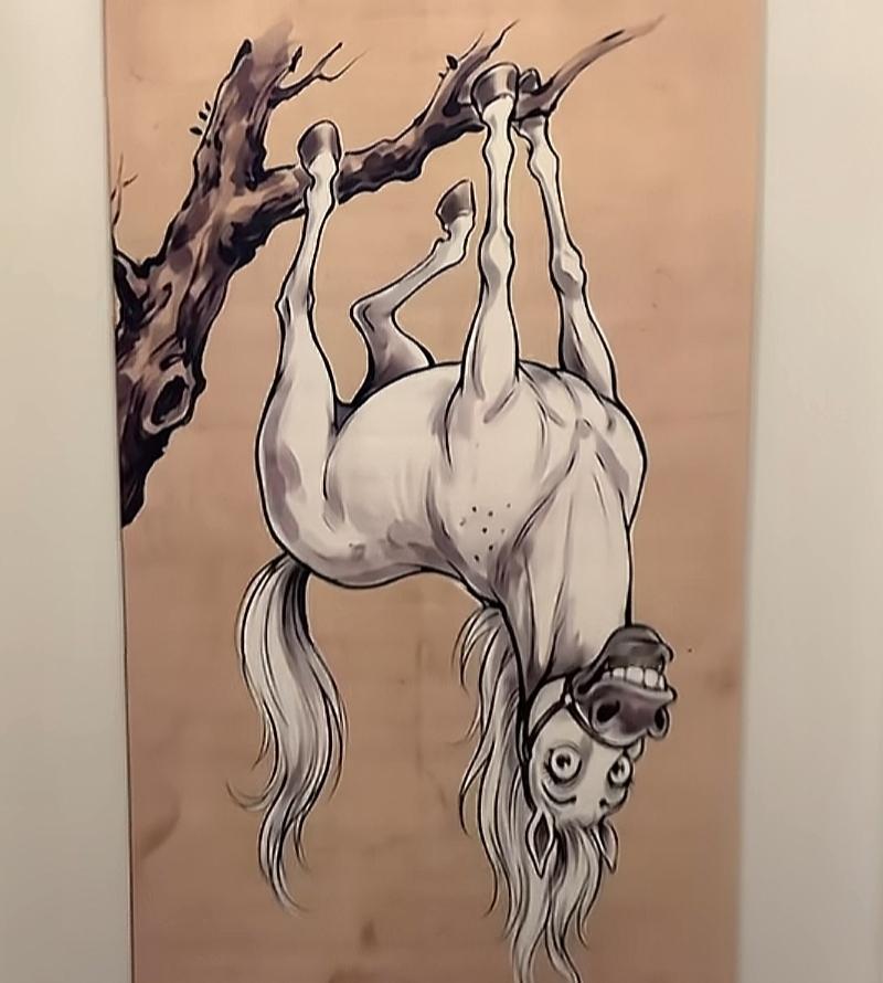 这匹马在树上倒挂着，表情搞怪。看图猜词语，开心快乐，这个图很搞笑。是什么词语呢？