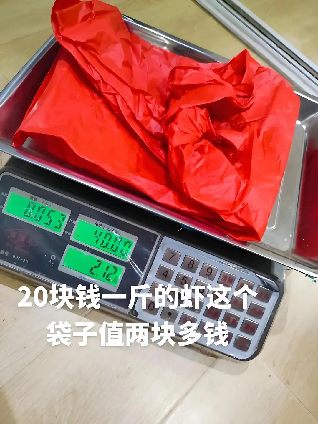 买虾连带塑料袋一起称。一个袋子，顶32只虾。上海青浦码头街水产摊，用加厚塑料袋装