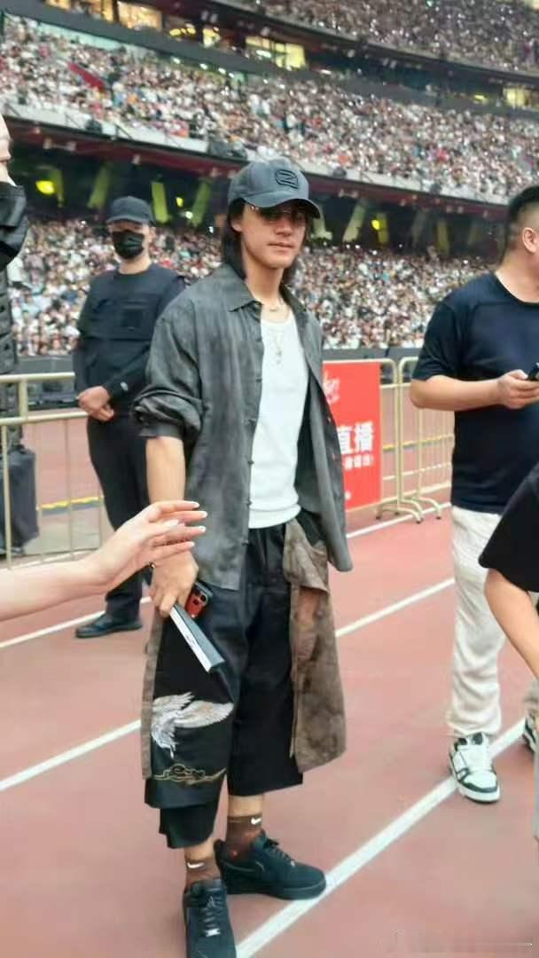 镜头扫到他时他完全没有防备，反应过来立刻乖乖打招呼，眼神里还有点不好意思。这种又